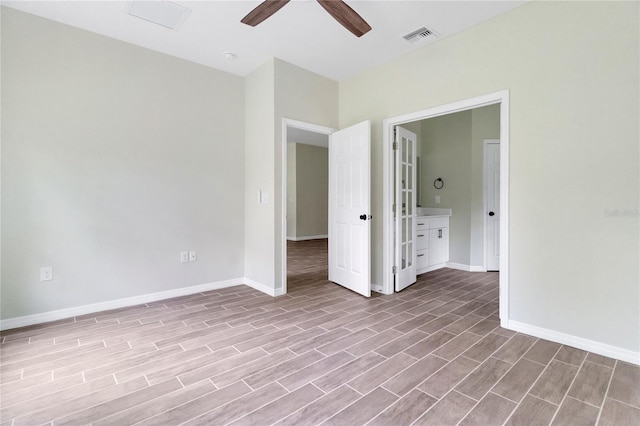 unfurnished bedroom with ceiling fan, connected bathroom, and light hardwood / wood-style flooring