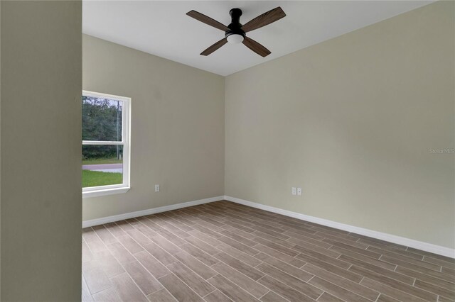 unfurnished room with ceiling fan and hardwood / wood-style flooring