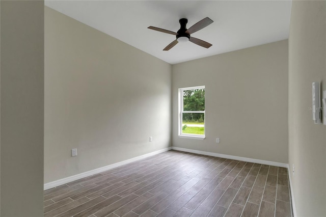 spare room with ceiling fan and wood-type flooring