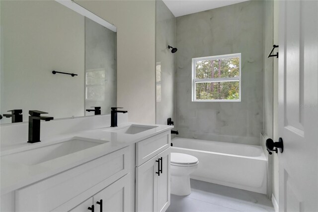 full bathroom with double vanity, bathing tub / shower combination, and toilet