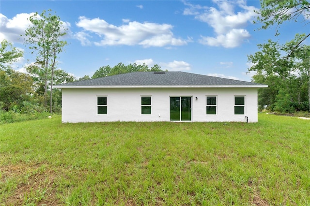 rear view of property with a yard