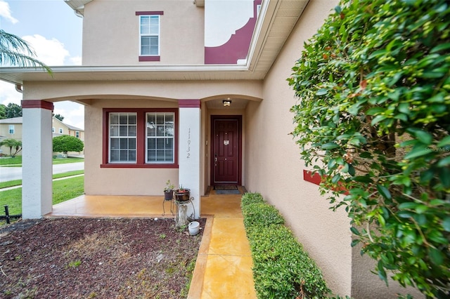 property entrance featuring stucco siding