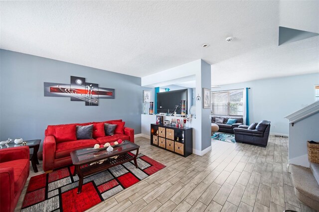 living room featuring light hardwood / wood-style flooring and a textured ceiling