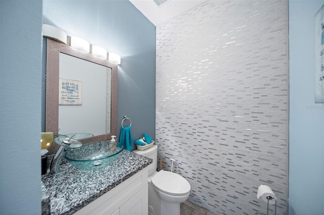 bathroom featuring toilet and vanity