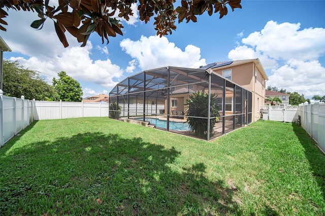 view of yard with glass enclosure and a fenced in pool