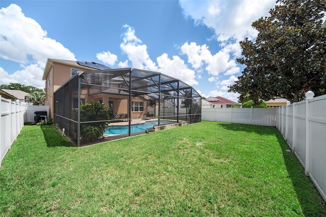 view of yard with a lanai and a fenced in pool