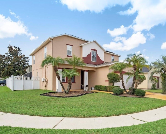 view of front of property featuring stucco siding, driveway, a front yard, and fence