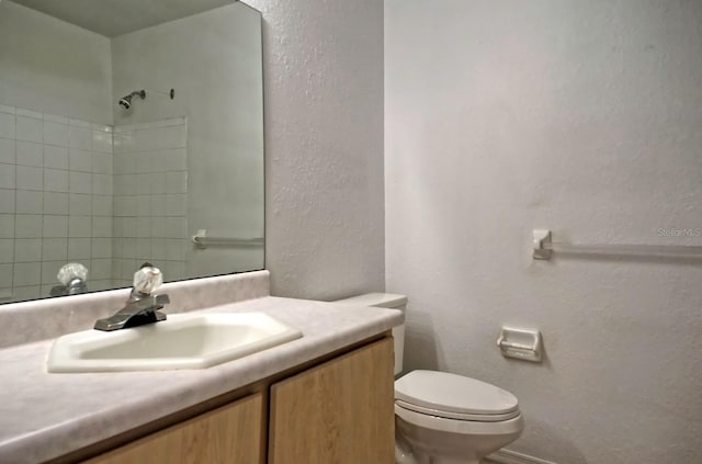 bathroom featuring toilet and vanity