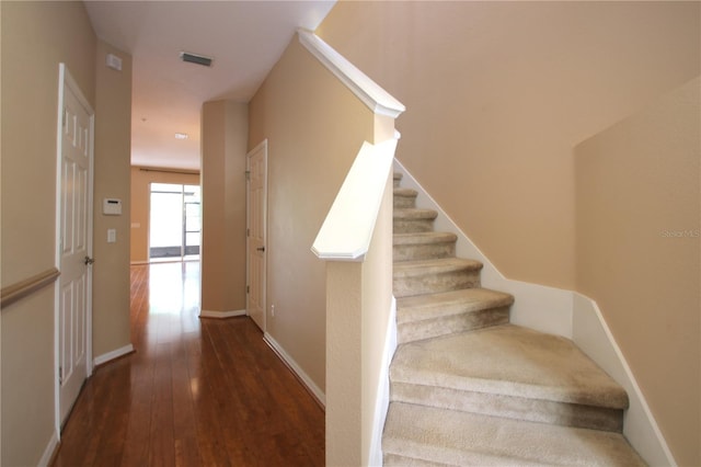 stairs featuring wood-type flooring