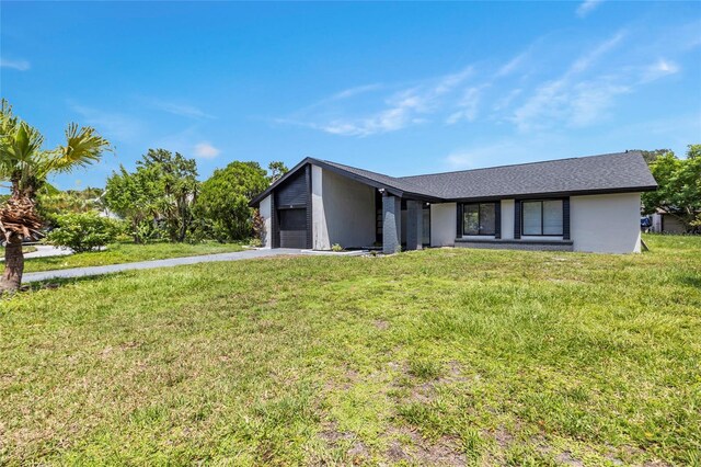 ranch-style house with a front yard and a garage