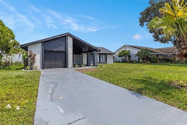 ranch-style home with a front yard and a garage