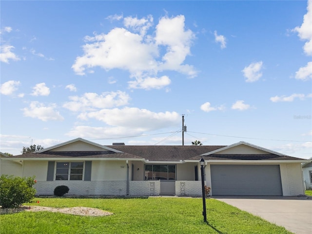 single story home with a garage and a front lawn