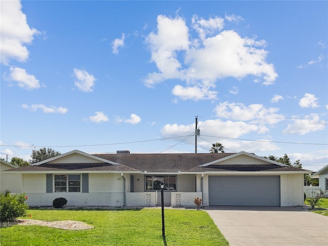 single story home with a garage and a front lawn