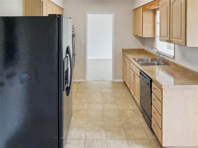 kitchen featuring dishwasher, light brown cabinetry, sink, and stainless steel fridge