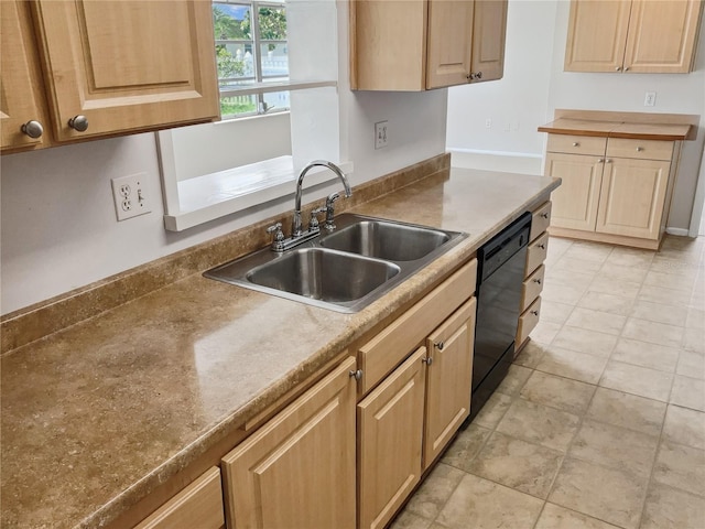 kitchen featuring light brown cabinets, dishwasher, and sink