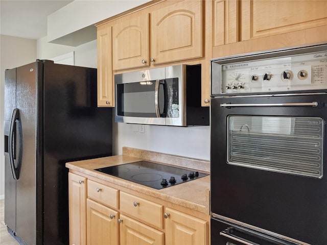 kitchen with black appliances and light brown cabinets