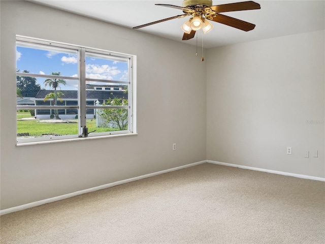 spare room with carpet floors and ceiling fan