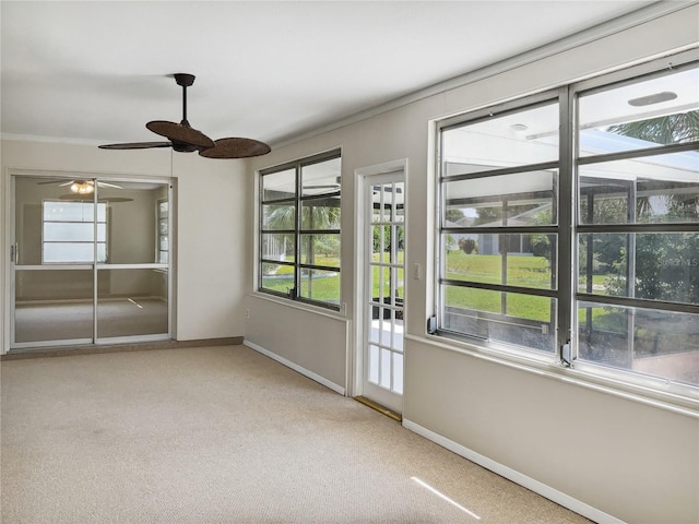 empty room featuring ceiling fan, ornamental molding, and light colored carpet