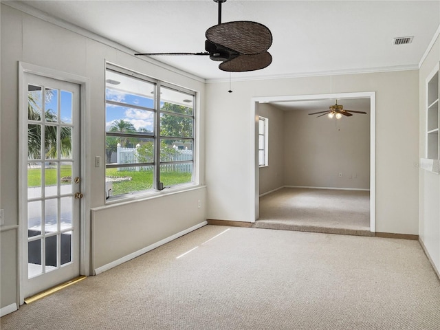 unfurnished room with ceiling fan, carpet, and ornamental molding