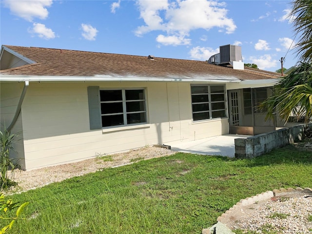 rear view of house featuring a yard, cooling unit, and a patio