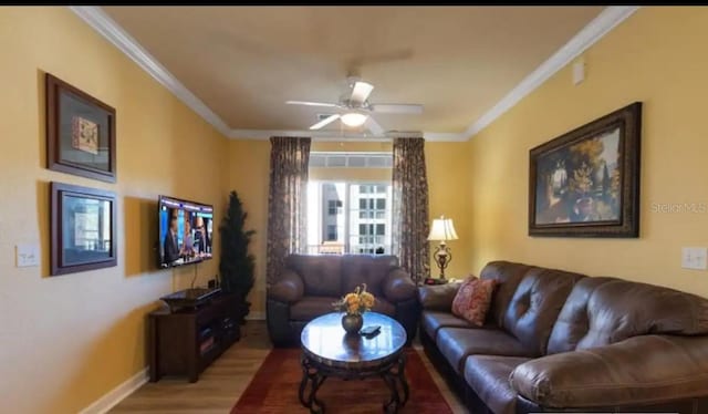 living room with hardwood / wood-style flooring, ceiling fan, and ornamental molding