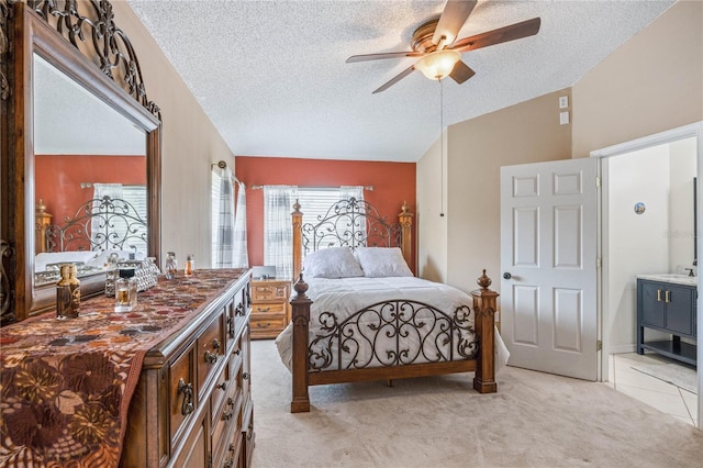 bedroom featuring a ceiling fan, lofted ceiling, light colored carpet, and a textured ceiling