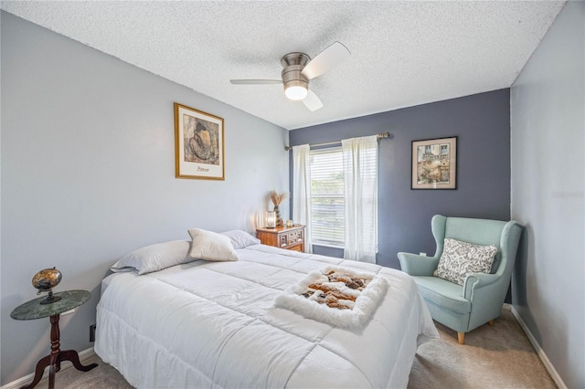 bedroom featuring a textured ceiling, carpet floors, a ceiling fan, and baseboards