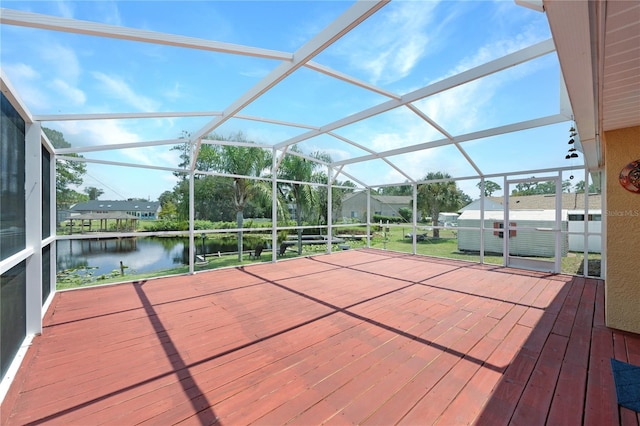 deck with a lanai, a water view, and a jacuzzi