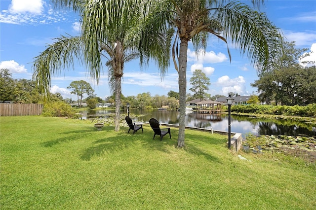 view of yard featuring a water view and fence