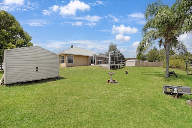 view of yard with a lanai and fence