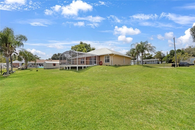 exterior space with a lanai and a lawn