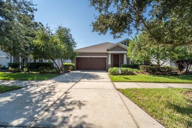 view of front of home featuring a garage and a front yard