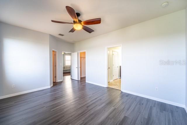 unfurnished bedroom with dark hardwood / wood-style floors and ceiling fan