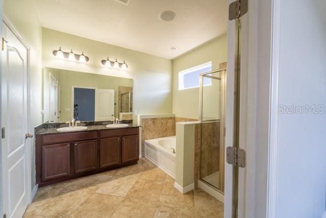 bathroom featuring vanity and separate shower and tub