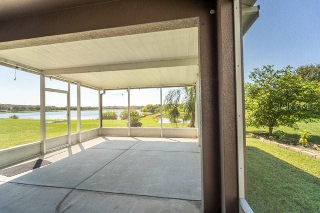 unfurnished sunroom featuring a water view and a healthy amount of sunlight