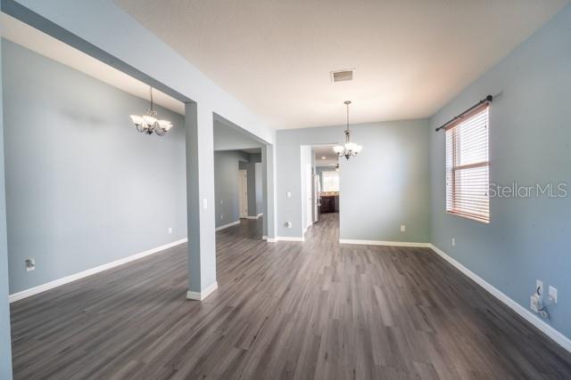 interior space with dark hardwood / wood-style flooring and a chandelier