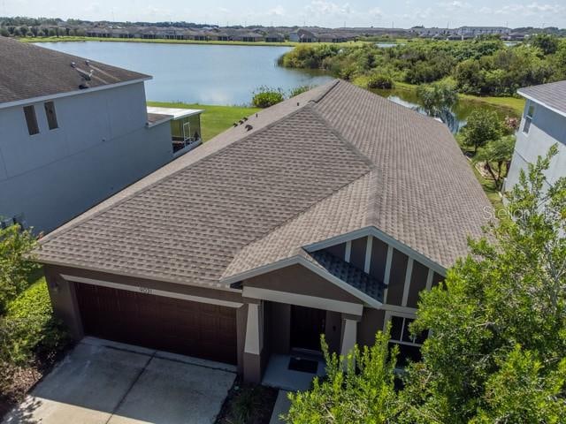 birds eye view of property with a water view