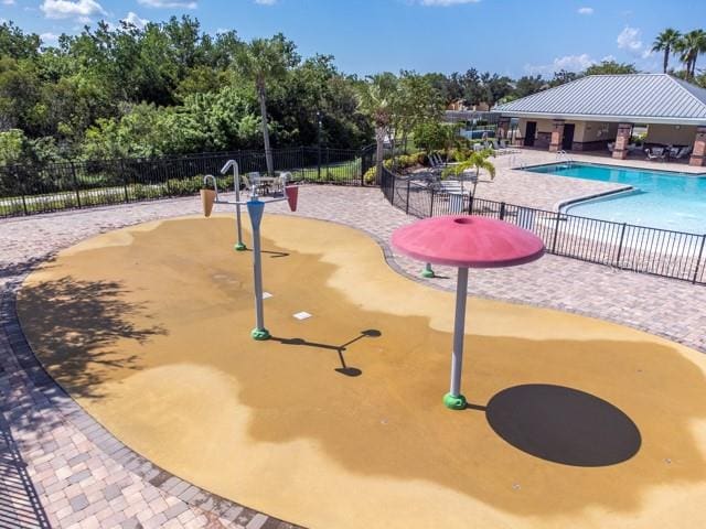 view of home's community with a pool and a patio area