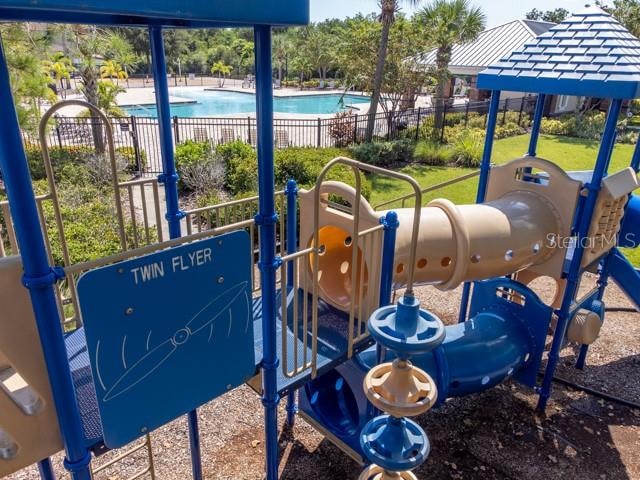 view of playground with a community pool