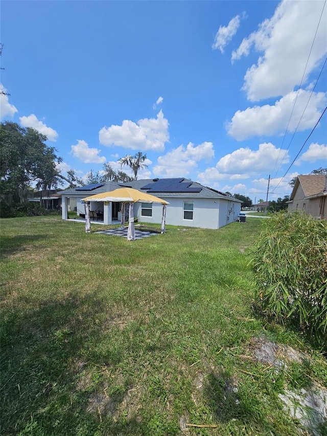 rear view of property with a lawn