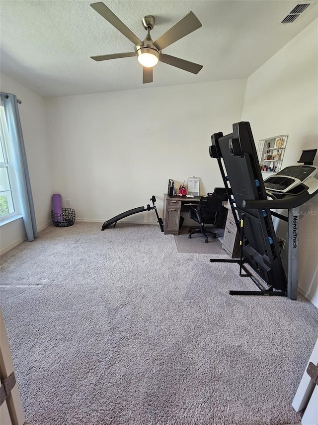 home office featuring ceiling fan, light colored carpet, and a textured ceiling