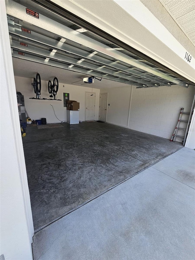 garage featuring a garage door opener and electric panel