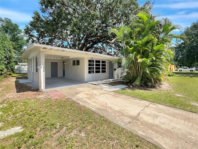 view of front facade with a carport and a front lawn