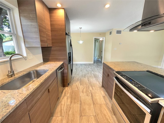 kitchen featuring sink, stainless steel appliances, light stone countertops, and exhaust hood