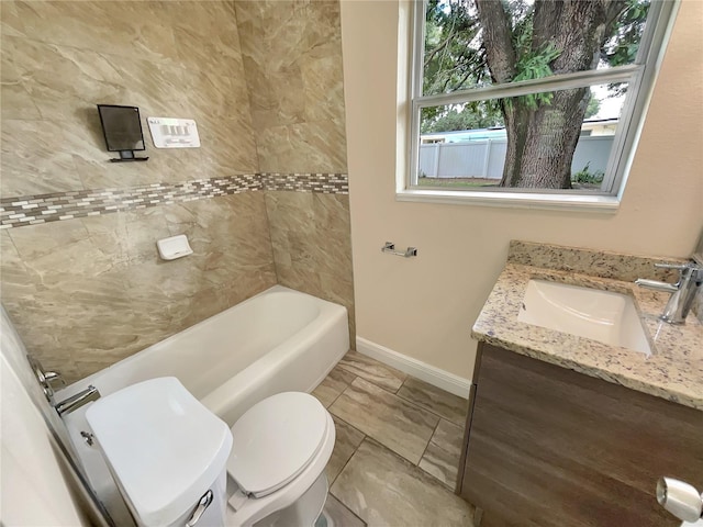 full bathroom featuring vanity, tiled shower / bath combo, and toilet