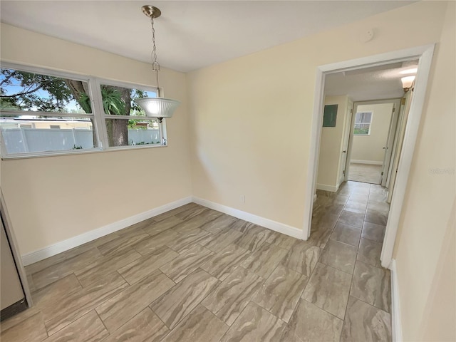 unfurnished dining area featuring light tile patterned floors