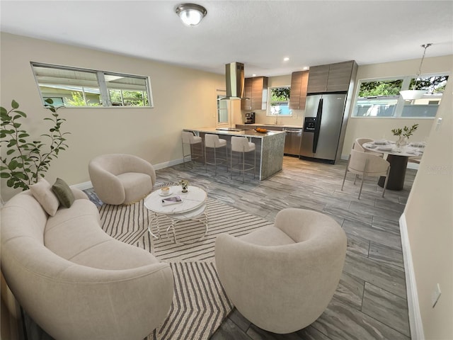 living room featuring light hardwood / wood-style flooring and a healthy amount of sunlight