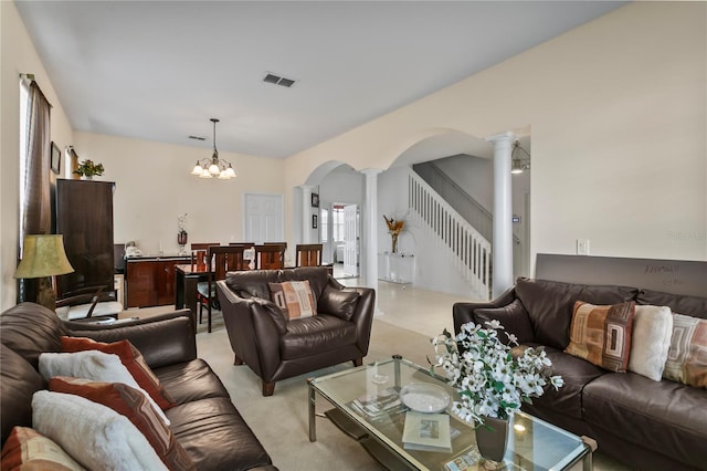 living room with a chandelier and decorative columns