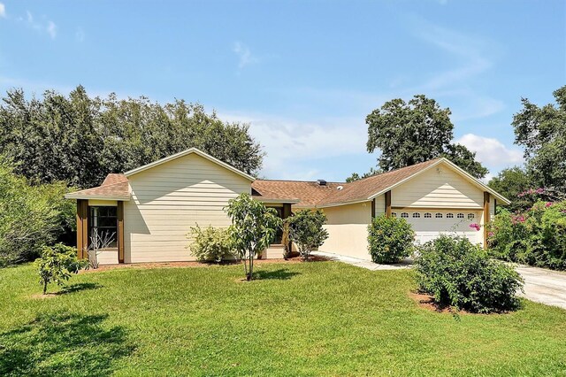 ranch-style home with a front lawn and a garage