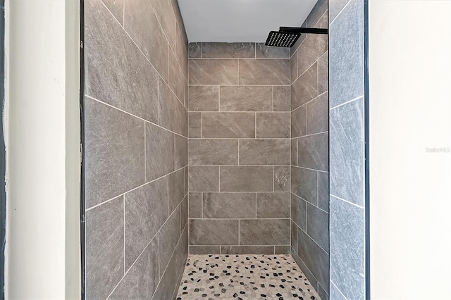 bathroom with tiled shower